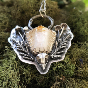 Close up of owl skull and ferns in silver citrine necklace